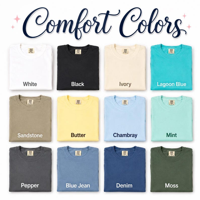May include: A colour chart titled Comfort Colors displaying twelve folded t-shirts in various shades: white, black, ivory, lagoon blue, sandstone, butter, chambray, mint, pepper, blue jean, denim, and moss, each with a visible neck label.