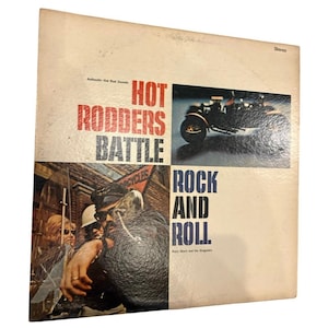 Pode incluir: Capa de álbum de vinil vintage para "Hot Rodders Battle Rock and Roll" de Baby Short and His Dragsters. A capa apresenta uma foto em preto e branco de uma motocicleta e um grupo de pessoas.