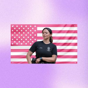 May include: A pink American flag with white stars and stripes is in the background. A person wearing a black short-sleeved shirt with the name "CHEN" and a police badge is in the foreground. The person is wearing a watch and a utility belt.