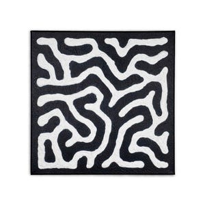 May include: Square abstract artwork in black and white. The piece has a textured black background with a white, maze-like pattern. The white lines are thick and winding, creating a strong contrast against the dark backdrop. The artwork is mounted on a square frame.
