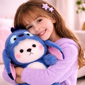 May include: A plush blue stuffed animal with large eyes, pink cheeks, and long ears is being held. The stuffed animal is in the shape of a character. The person holding the stuffed animal is wearing a purple sweater and has flower hair clips.