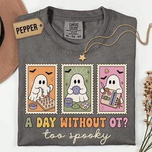 May include: A charcoal gray t-shirt featuring three rectangular stamp-style graphics of ghosts engaged in occupational therapy activities, with the text A DAY WITHOUT OT? too spooky printed in colorful, retro-style lettering below the designs.