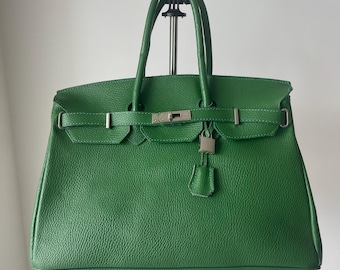 Tweedehands groene leren draagtas, gestructureerde vintage handtas, elegante handtas met handvat aan de bovenkant.