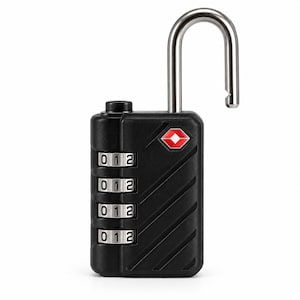 May include: A black TSA-approved combination padlock with a silver metal shackle in the open position. The lock features four rotating number dials currently set to zero, one, and two, and a small red diamond-shaped logo on the front casing.