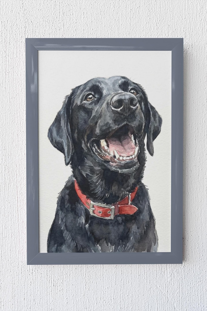 May include: Watercolor painting of a black Labrador Retriever with a red collar. The dog is smiling with its mouth open, showing its teeth and pink tongue. The artwork is framed in a gray rectangular frame.