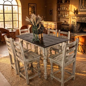 May include: A rustic dining set with a dark brown rectangular table and six matching chairs. The chairs and table legs are painted white with a distressed finish. The room has a warm, inviting atmosphere with a fireplace and bar.