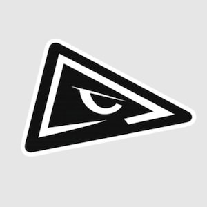 May include: A black and white triangular sticker featuring a stylized eye design. The eye is composed of a curved white line and a black outline, set against a black triangle with a white border. The sticker has a clean, modern aesthetic.