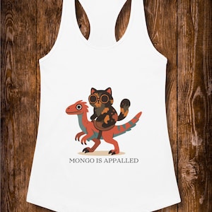 May include: White racerback tank top with a graphic of a cat wearing glasses riding a red and orange dinosaur. The text "MONGO IS APPALLED" is below the graphic.