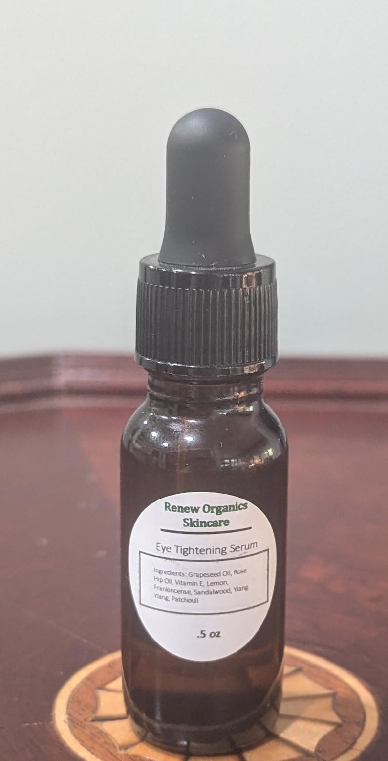 May include: A brown glass bottle of Renew Organics Eye Tightening Serum with a black dropper. The label lists ingredients like grapeseed oil and rose hip oil. The bottle contains .5 oz of serum.