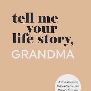 May include: A tan book cover with the black text "tell me your life story, GRANDMA" in a mix of serif and sans-serif fonts. Three white dots appear at the top, and a white circular badge at the bottom reads "A Grandmother's Guided Journal and Memory Keepsake Book."