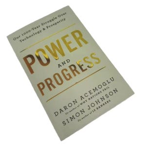May include: A book titled Power and Progress: Our 1000-Year Struggle Over Technology & Prosperity by Daron Acemoglu and Simon Johnson. The cover is off-white with large, reflective gold metallic lettering for the title and black text for the authors.