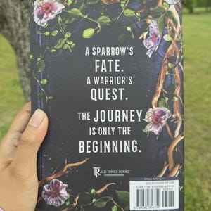 May include: A book cover with a dark background, floral and vine accents, and the text "A Sparrow's Fate. A Warrior's Quest. The Journey Is Only The Beginning." The Red Tower Books logo is visible.