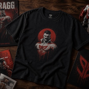 May include: Black t-shirt featuring a graphic of a muscular man with a red and white emblem, set against a red circle. The word "THRAGG" is visible on a book, along with the title "Invincible: The Viltrumite War". A figurine is also present.