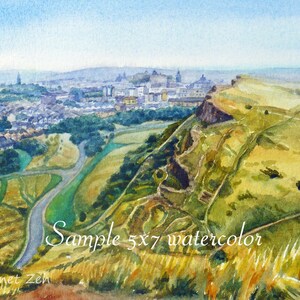 May include: A watercolor painting of a city skyline with a hill in the foreground. The city is in the distance and the hill is covered in green grass and trees. The sky is blue and there are clouds in the sky. The painting is signed "Janet Zeh" in the lower left corner. The text "Sample 5x7 watercolor" is written in the lower right corner.