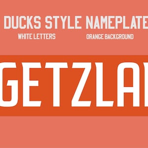 May include: A rectangular nameplate featuring the text GETZLAF in bold white capital letters centered on a solid orange background. Above the name, the text DUCKS STYLE NAMEPLATE, WHITE LETTERS, and ORANGE BACKGROUND are printed in white.