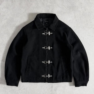 May include: A black jacket with a collar and silver clasps down the front. The jacket has a simple, classic design, suitable for various occasions. The material appears to be a soft, matte fabric.