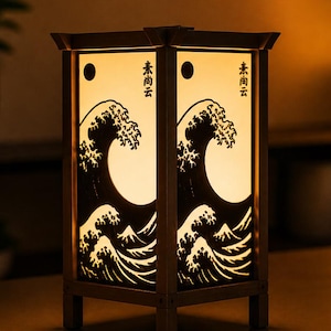 Può includere: Una lanterna in legno con un design a onde giapponesi. La lanterna rettangolare ha una fonte di luce all'interno, che illumina il motivo a onde e il testo giapponese. La cornice è di colore marrone scuro.