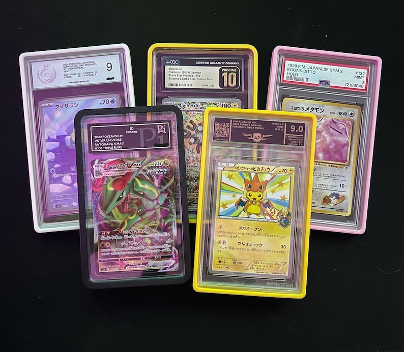 May include: Five graded Pok&eacute;mon trading cards in protective cases. The cards feature various characters and are encased in white, black, pink, and yellow holders. Each case displays a grade and other information.