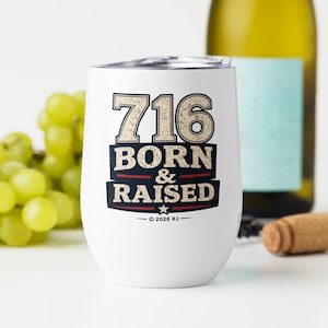 May include: A white stainless steel stemless wine tumbler with a clear lid. The front features the text 716 BORN & RAISED in a distressed, vintage-style font with navy blue and red accents, along with a small star and the text 2026 RJ.