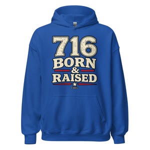 May include: A royal blue hooded sweatshirt featuring the text 716 BORN & RAISED in a distressed cream font with red horizontal lines and a small white star. The design includes the copyright text 2026 RJ at the bottom center of the graphic.