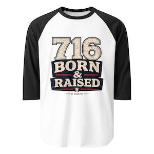 May include: A white baseball t-shirt with black three-quarter length sleeves featuring a graphic print that reads 716 BORN & RAISED in a distressed font, with a small star and the text 2026 RJ centered below the main design.