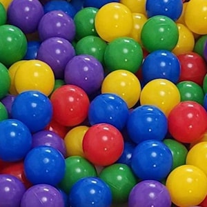 May include: A close-up shot of a pile of colorful plastic balls. The balls are in various colors, including red, yellow, green, blue, and purple. The balls are all the same size and appear to be made of a smooth, shiny plastic.