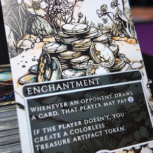May include: A Smothering Tithe card featuring a detailed illustration of coins and floral elements. The card text reads "ENCHANTMENT" and includes game instructions. The card has a white border and a black background.