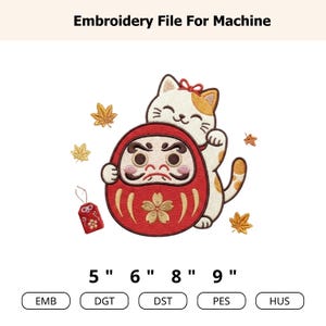 May include: An embroidery file for machine featuring a white and orange cat leaning on a red Daruma doll with a gold cherry blossom design. Surrounded by yellow maple leaves and a small red charm, with text reading Embroidery File For Machine 5" 6" 8" 9" EMB DGT DST PES HUS.