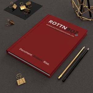 May include: A dark red hardcover notebook titled ROTTNBOZ WORKPLACE DOCUMENTATION LOG with the text Document. Protect. Rise. printed on the cover. The notebook is accompanied by one gold and one black pencil and several gold binder clips.
