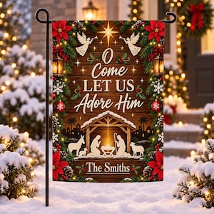 May include: A rectangular garden flag featuring a wood-plank background with a nativity scene at the bottom, the text O Come Let Us Adore Him, and the name The Smiths. The border is decorated with green pine branches, red poinsettias, and lanterns.