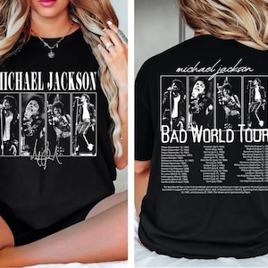 May include: Black t-shirt featuring a graphic of Michael Jackson with the text "MICHAEL JACKSON" on the front. The back of the shirt displays "BAD WORLD TOUR" with tour dates and images of Jackson.