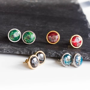 May include: Six pairs of earrings with different coloured circuit board designs. The earrings are made of gold and silver metal.