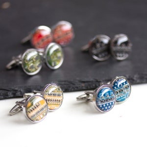 May include: A collection of cufflinks with circuit board designs. The cufflinks feature various colors, including red, green, yellow, and blue, with silver-toned metal settings. The designs showcase intricate electronic components.