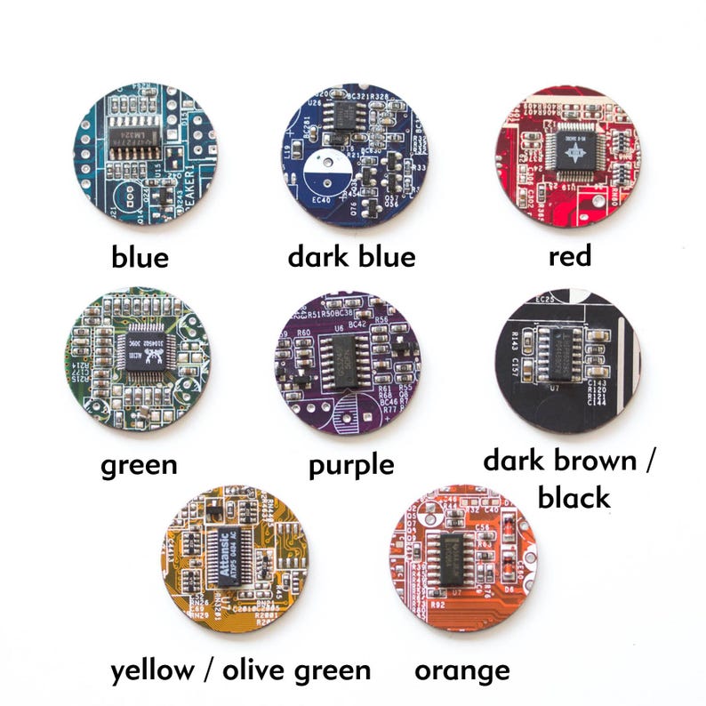 May include: A collection of nine circular circuit board components in various colors, including blue, dark blue, red, green, purple, dark brown/black, yellow/olive green, and orange. Each component has integrated circuits and text labels.