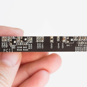 May include: A close-up of a black circuit board with various components and labels, including "C241", "C242", "C243", "R323", "PCI1", "R332", "R333", "R329", "C254", "C249", "C250", "C251", "C252", "C244", "C253", "041", "R324", "R326", "C245", "R327", "C246", "R325", "328", "R330", "R331".