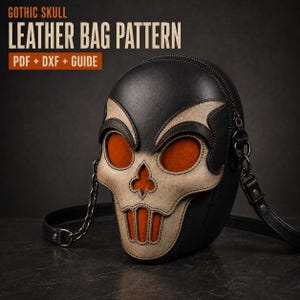May include: A black and beige leather bag shaped like a skull with orange accents in the eye and mouth openings. The bag features a black metal chain strap and is presented with text reading GOTHIC SKULL LEATHER BAG PATTERN PDF + DXF + GUIDE.