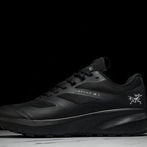 May include: Black athletic shoe with the text "NORVAN LD 3" and a logo on the side. The shoe has a thick sole and a mesh upper. The shoe is designed for running and outdoor activities.