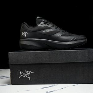 May include: A black athletic shoe, the Norvan 15, sits atop a black box. The shoe features a sleek design with the brand logo on the side. The box also has the brand logo in white. The background is black.