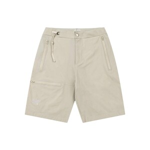May include: Khaki-colored shorts with multiple pockets and a zip closure. The shorts have a belt loop with a buckle and a small logo on the front pocket. The fabric appears lightweight and suitable for warm weather.