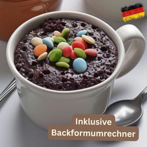 May include: A white mug filled with a chocolate cake, topped with colorful candies. A spoon rests beside the mug. The text "Inklusive Backformumrechner" is at the bottom of the image.