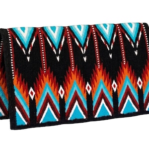 May include: A rectangular saddle pad featuring a black base with a repeating geometric pattern in turquoise, orange, white, and dark red. The design consists of vertical stripes and pointed chevron shapes, finished with a solid black border trim.