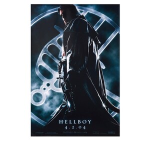 May include: A movie poster for "Hellboy" featuring a figure in a long coat holding a gun and a cross. The poster has a dark blue and gray color scheme with the movie title and release date, 4.2.04, at the bottom.