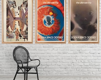 May include: Three framed movie posters for "2001: A Space Odyssey" hang on a white brick wall. The posters feature vibrant colors and imagery, including a space scene, an eye-like design, and a fetus. A black wicker chair sits in front of the wall.