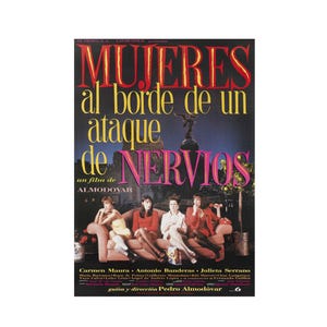 May include: A movie poster with the title "MUJERES al borde de un ataque de NERVIOS" in red and yellow text. The poster features a group of women seated on a pink sofa, with a cityscape backdrop.