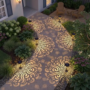 May include: A concrete garden path illuminated by several small solar-powered stake lights. Each light casts a distinct, intricate, swirling floral pattern of warm yellow light onto the walkway, creating a decorative shadow effect among the plants.