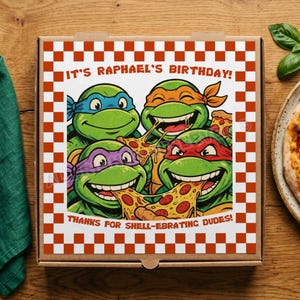 May include: A square cardboard pizza box featuring a red and white checkered border. The center graphic shows four green turtles wearing colored masks, eating pizza, with the text IT'S RAPHAEL'S BIRTHDAY! and THANKS FOR SHELL-EBRATING DUDES!
