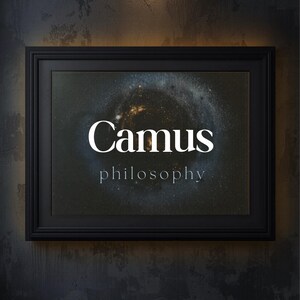 May include: A framed print featuring the name "Camus" in white, above the word "philosophy". The background is a dark, starry nebula. The black frame hangs on a textured, dark grey wall. The image is lit by a small overhead light.