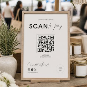 May include: A vertical rectangular sign in a light wood frame featuring the text SCAN to pay, a central QR code, and placeholders for business name, app name, social handles, and a logo. The sign includes the text Connect with us! and icons.