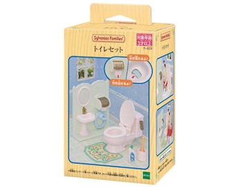 May include: A Sylvanian Families toilet set in a cardboard box. The set includes a white toilet, a sink with a mirror, a toilet paper holder, a floral rug, a cleaning bottle, and a brush. The packaging features Japanese text and illustrations.