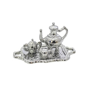 Puede incluir: Miniatura de juego de té plateado, que incluye una tetera, una jarra de crema, un azucarero y una bandeja. El juego tiene un acabado metálico reflectante y detalles finos. La bandeja tiene un borde decorativo.